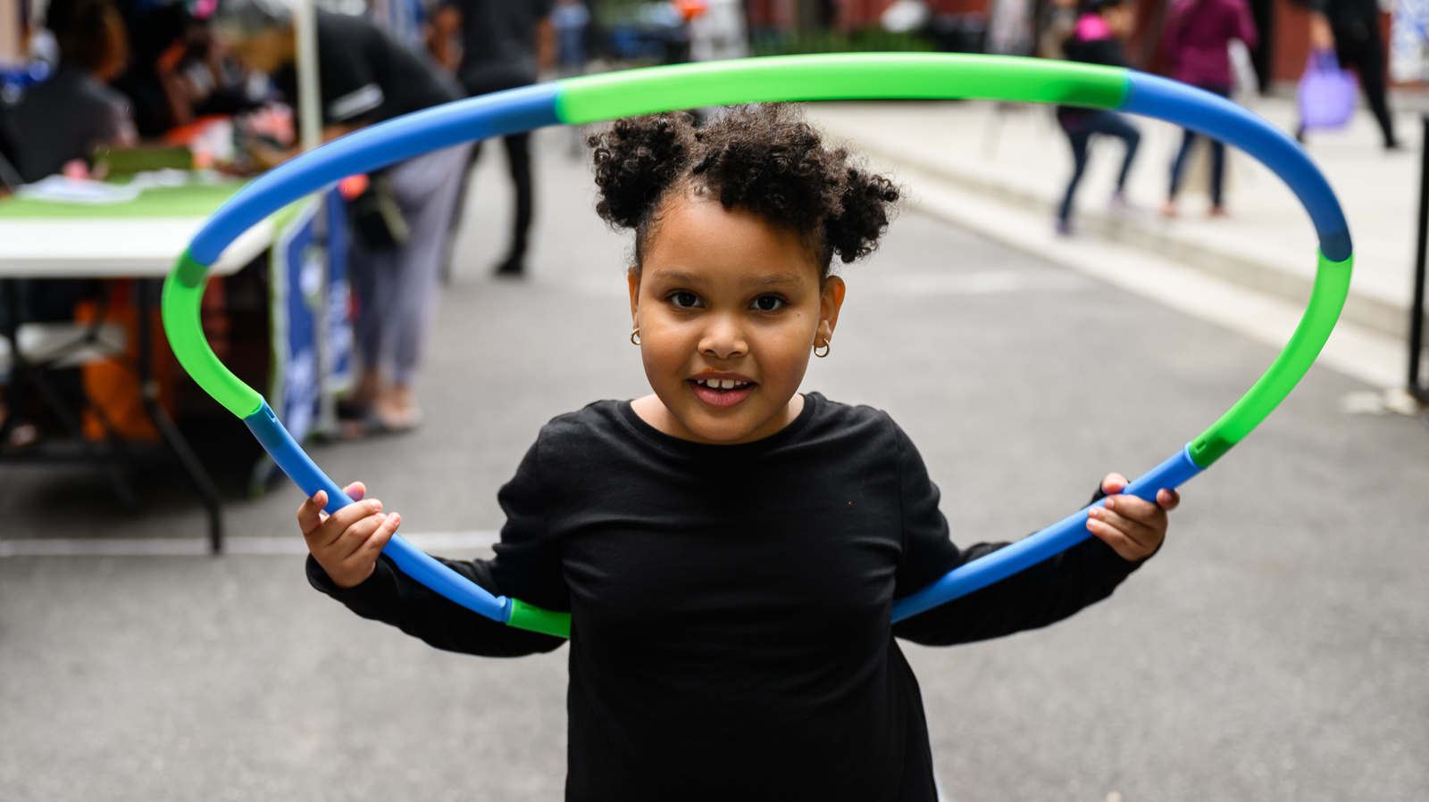 A girl with a hula hoop at Betances Houses. Credit: Catholic Charities New York