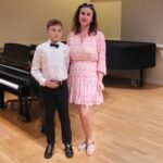 Olha, a Ukrainian refugee supported by Catholic Charities of New York, at her son’s piano recital.