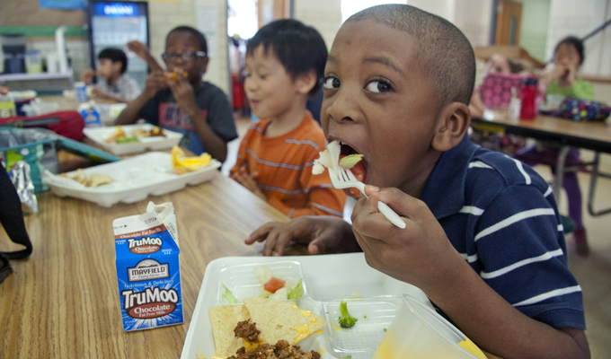 A child eating in a cafeteria.