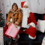 A smiling child with Santa during a toy distribution event at Betances Houses.