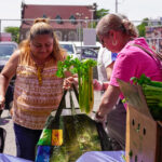 A client and volunteer at a Catholic Charities of New York food distribution.