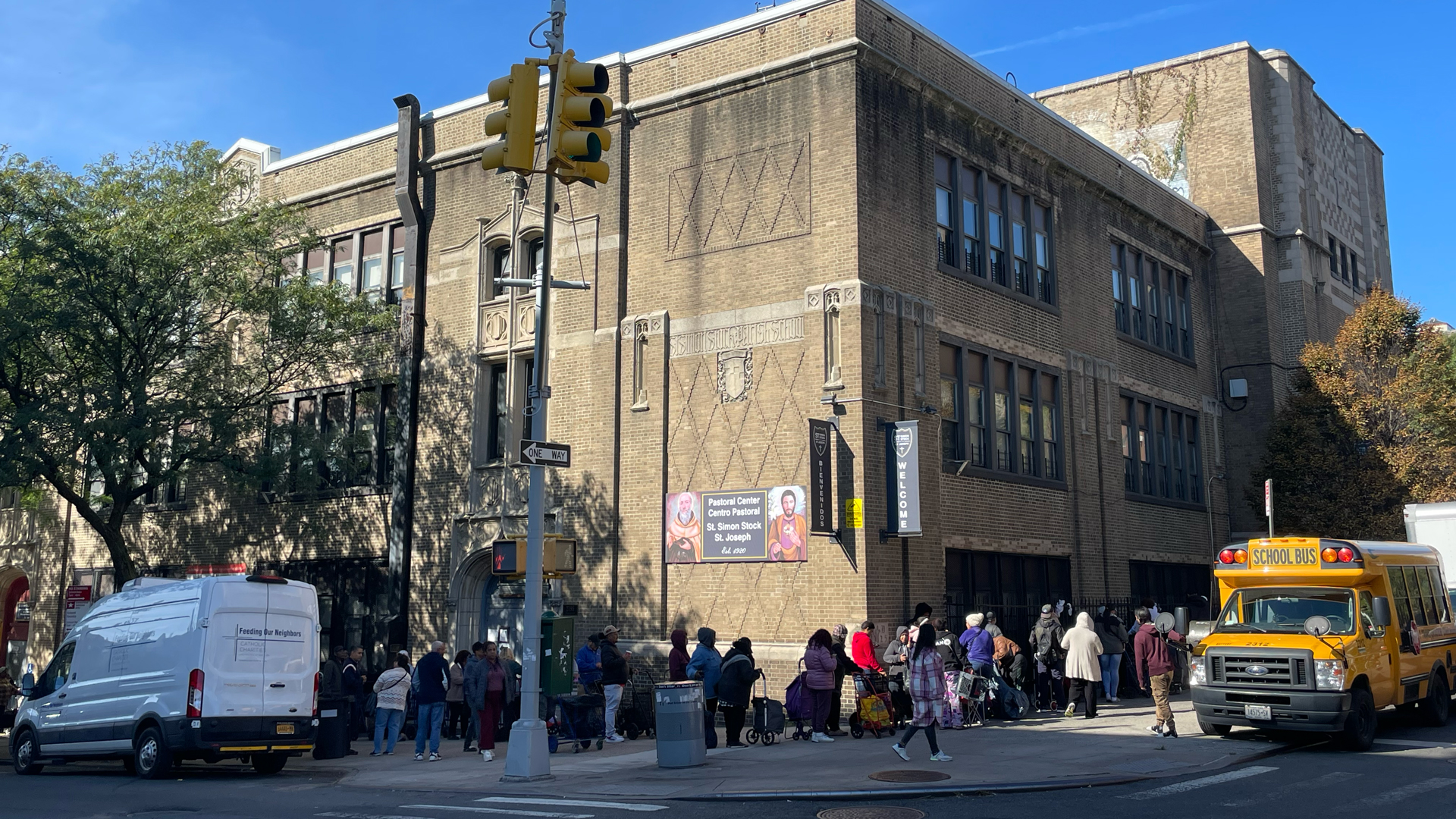 Community members lining around the block to receiving groceries during a food pantry distribution event at St. Simon Stock–St. Joseph Parish in the Bronx.