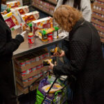 A woman holding pantry items at Catholic Chariites' Bronx Food Hub.