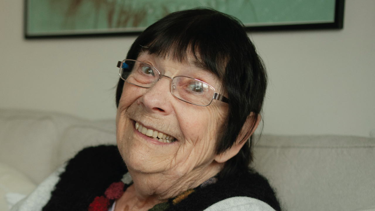 Alex, a longtime Washington Heights resident, sits in her apartment where she has lived since childhood.